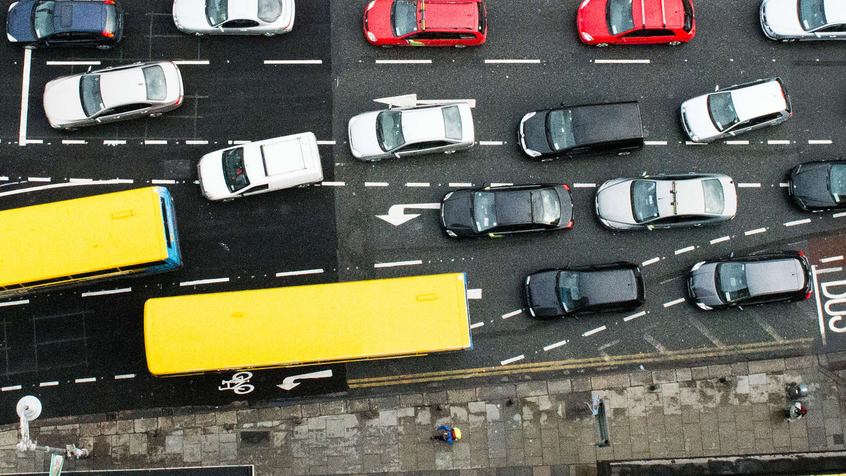 Overhead view of traffic in a city. Buses and cars waiting to cross a junction.