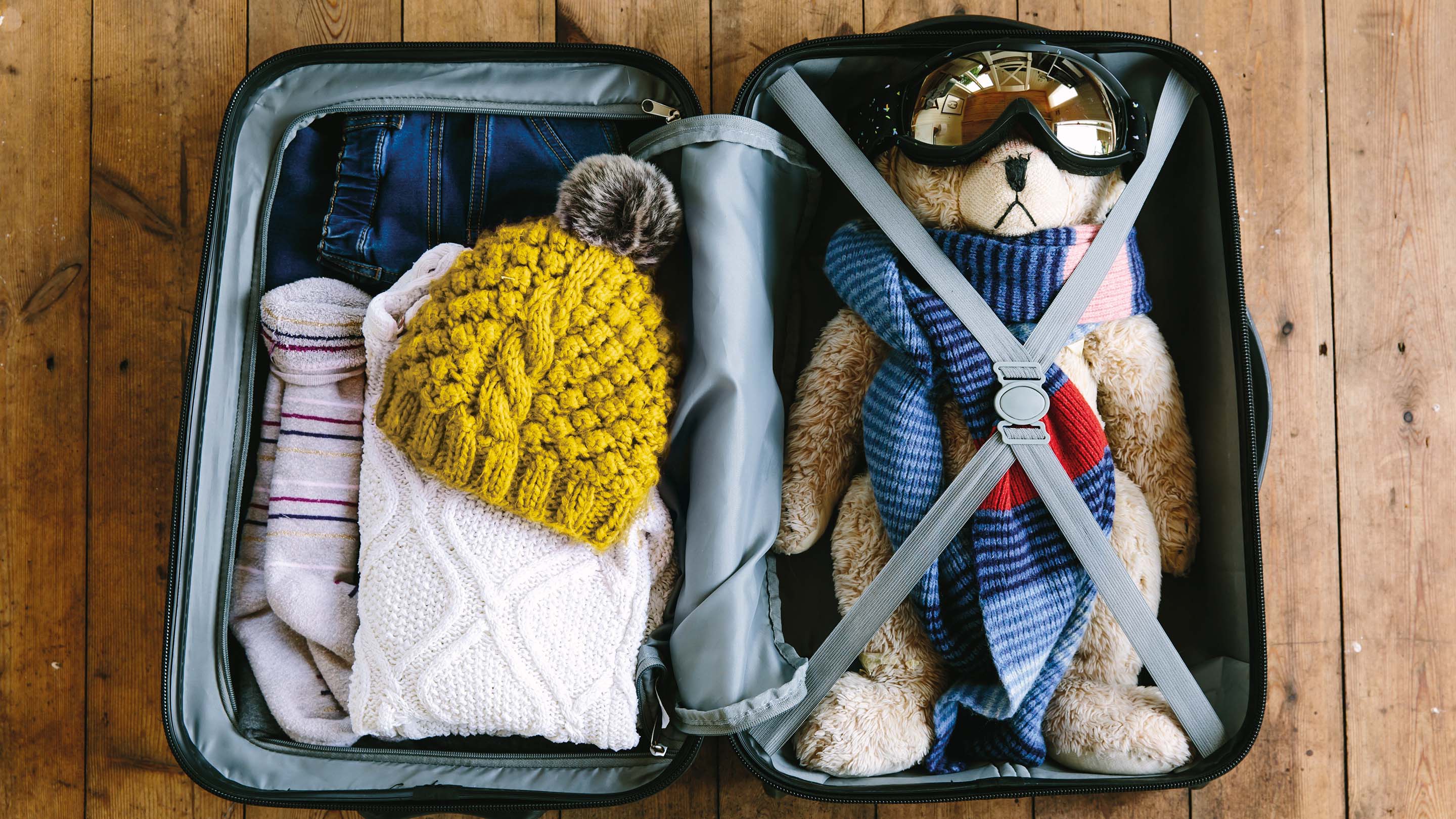 Child's ski holiday suitcase with teddy