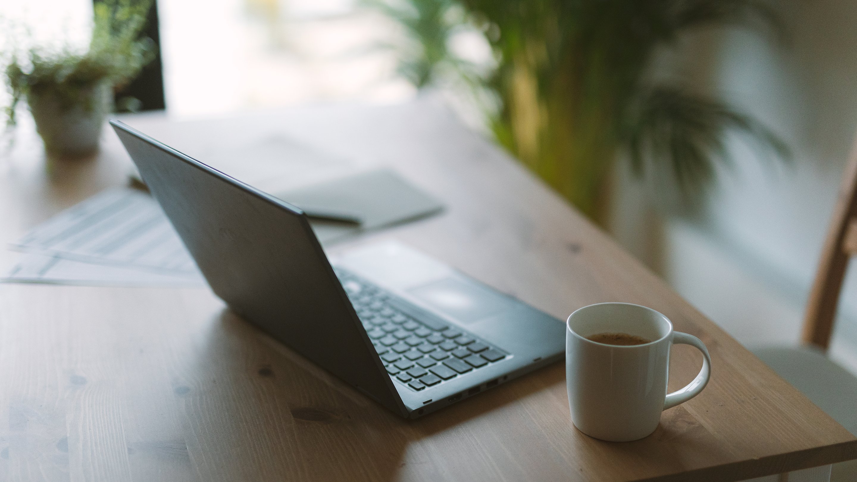 Mug and laptop on a table in a home
