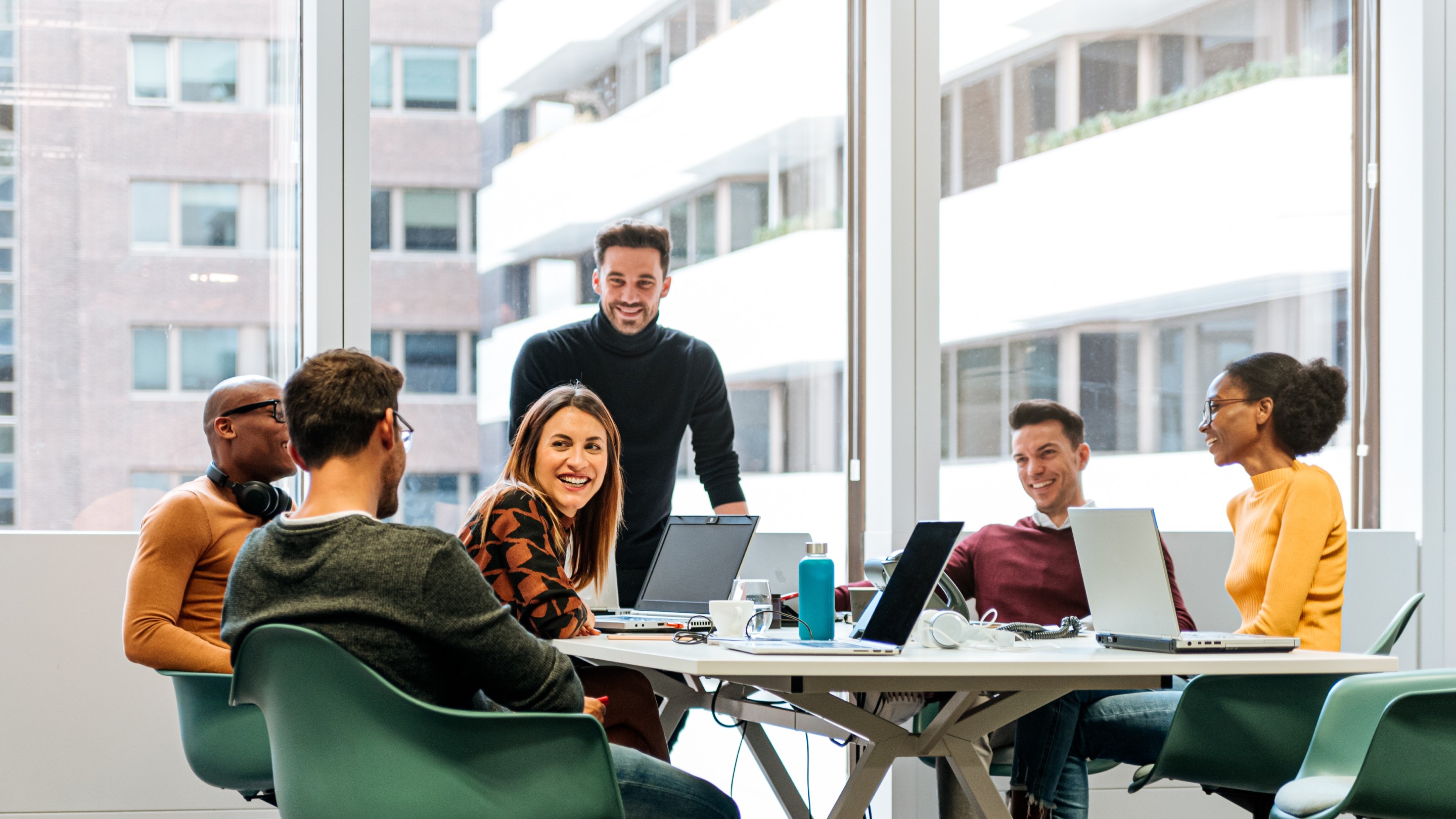 Coworkers chatting in a meeting room