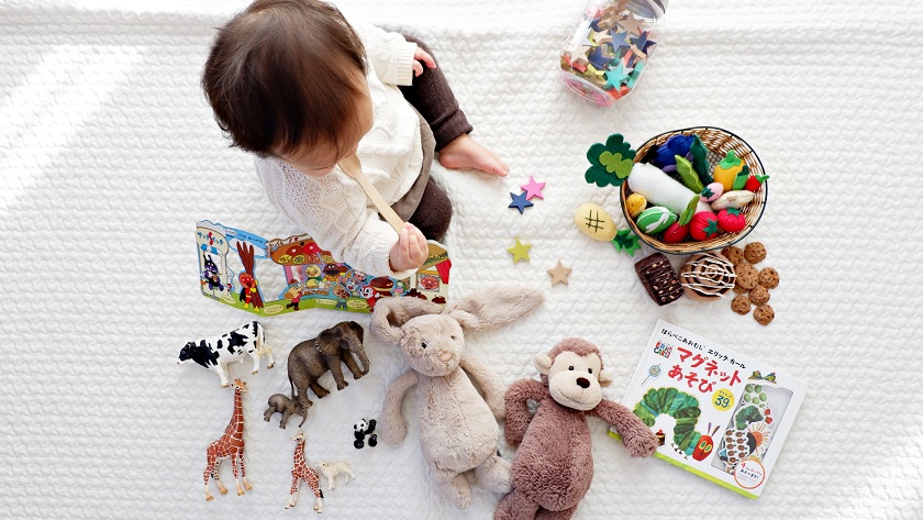 Image of a baby playing with toys