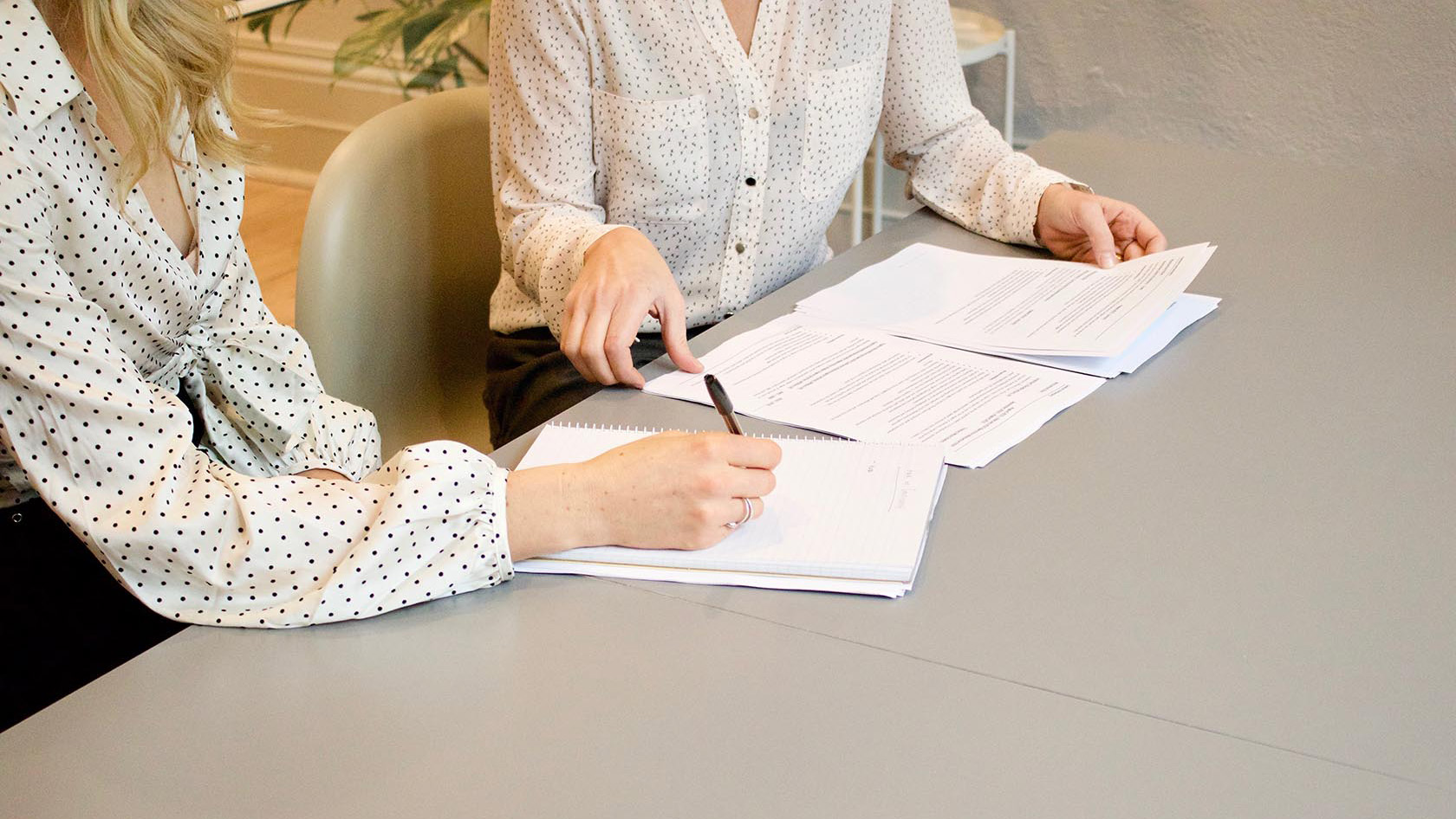 Image of two people looking at paperwork