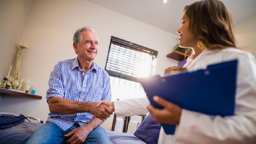 Image of a man shaking hands with a female doctor in a consulting