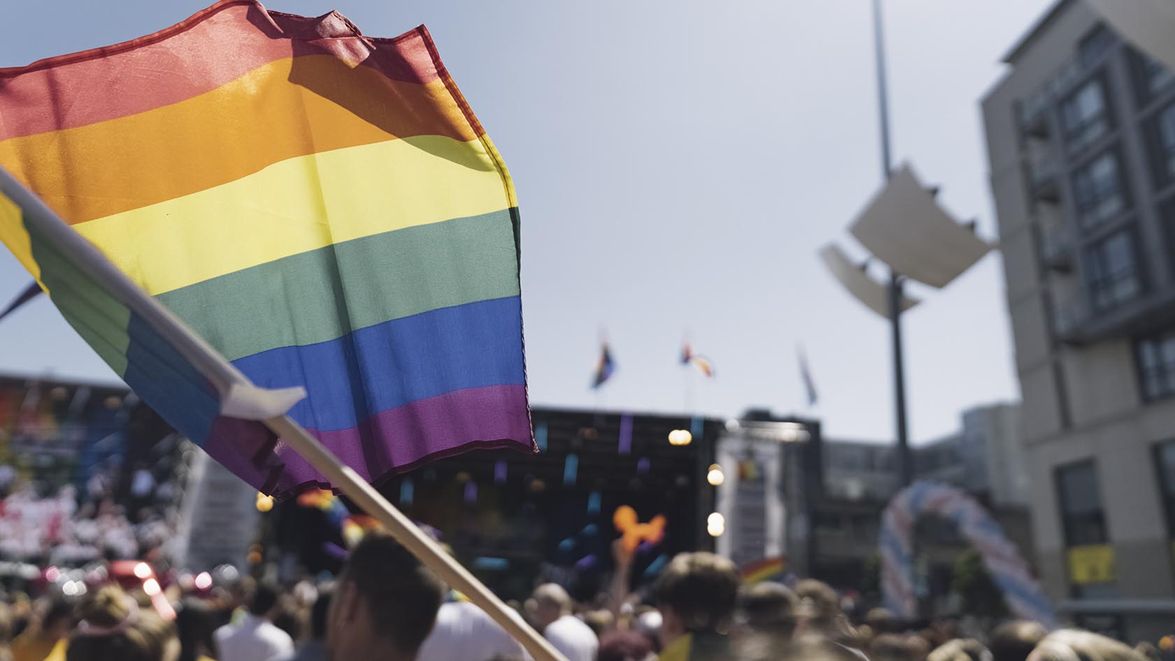 Pride flag flying at a Pride parade