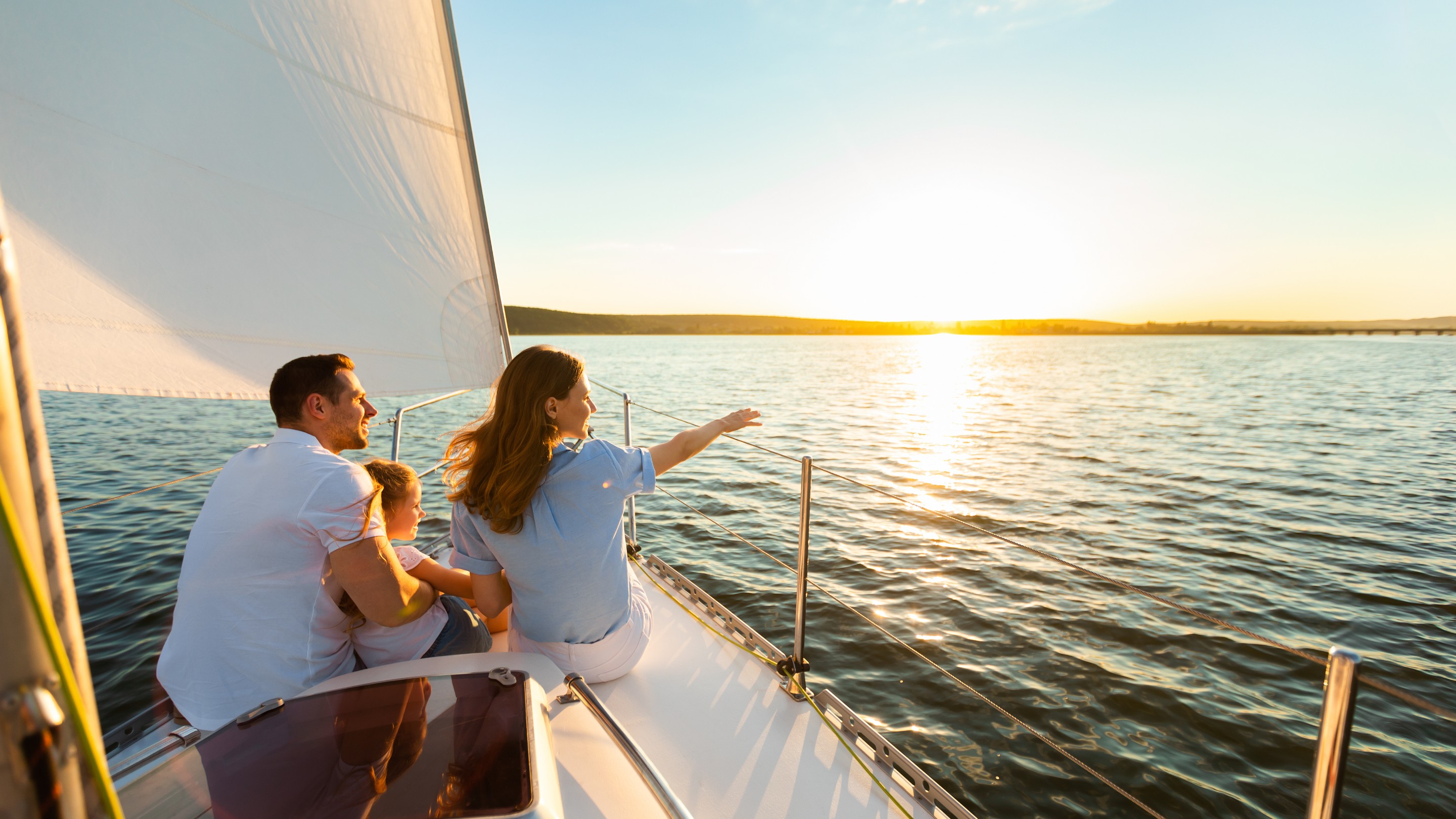 Family on a sailing yacht looking out at the sea
