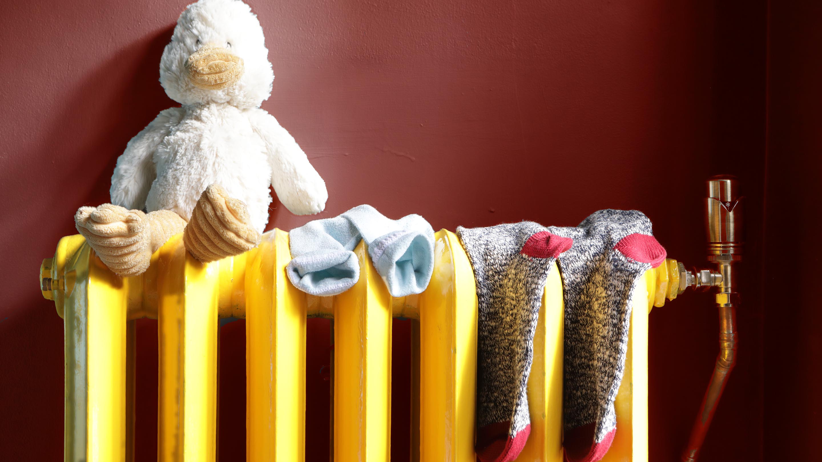 Soft toy on a yellow radiator