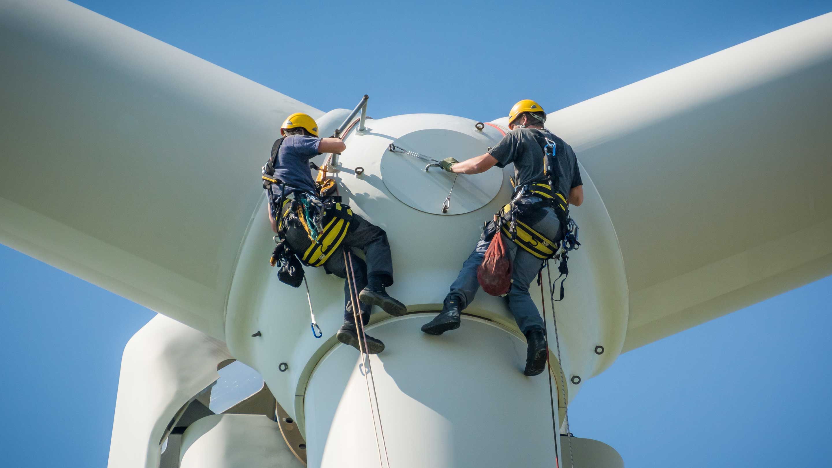 Workers fixing a windmill