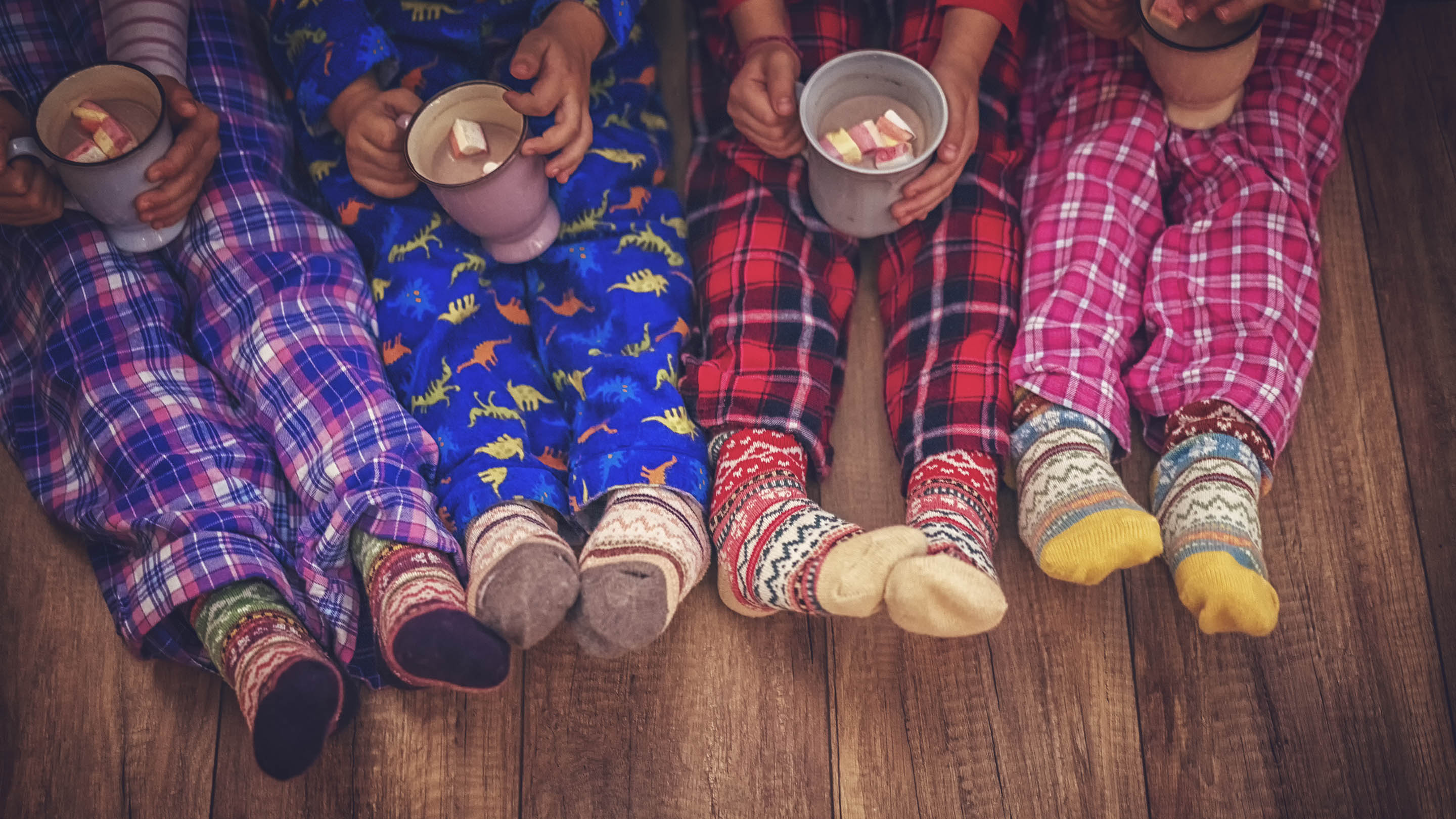 Kids in pyjamas with hot chocolate