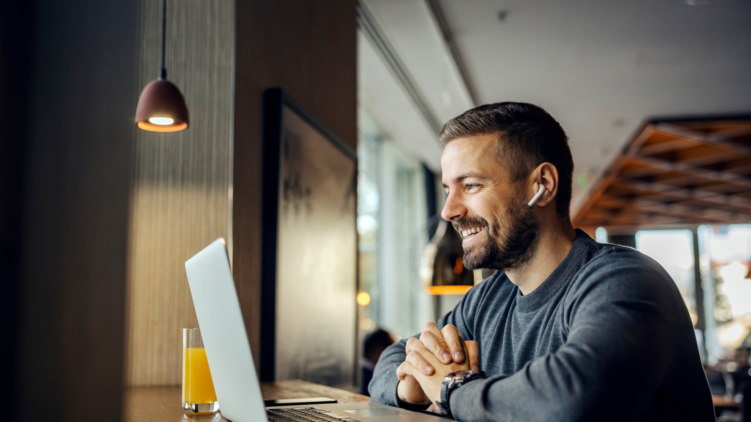 Man sitting at laptop smiling