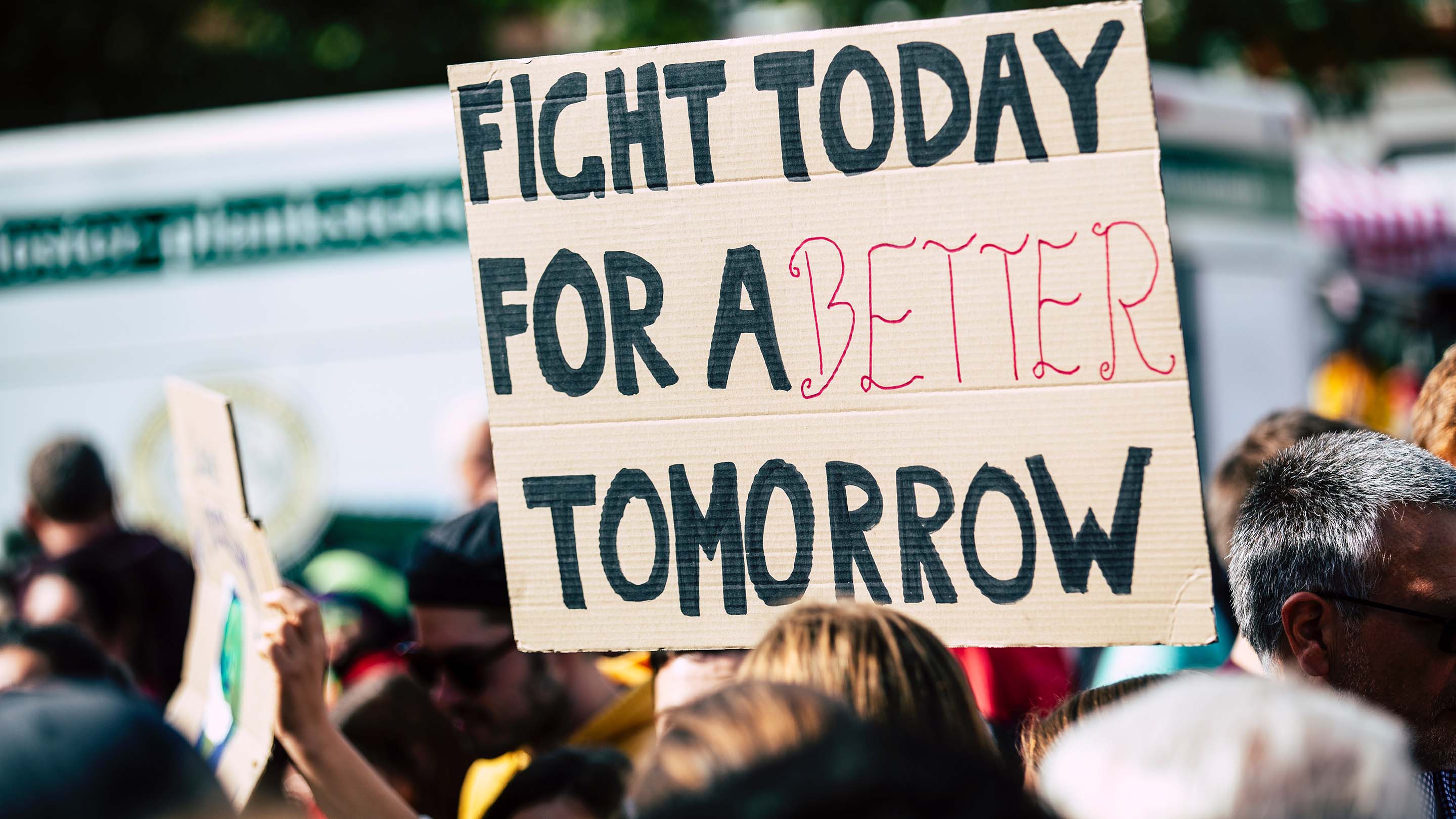 Sign reading 'fight today for a better tomorrow' being held at a climate rally