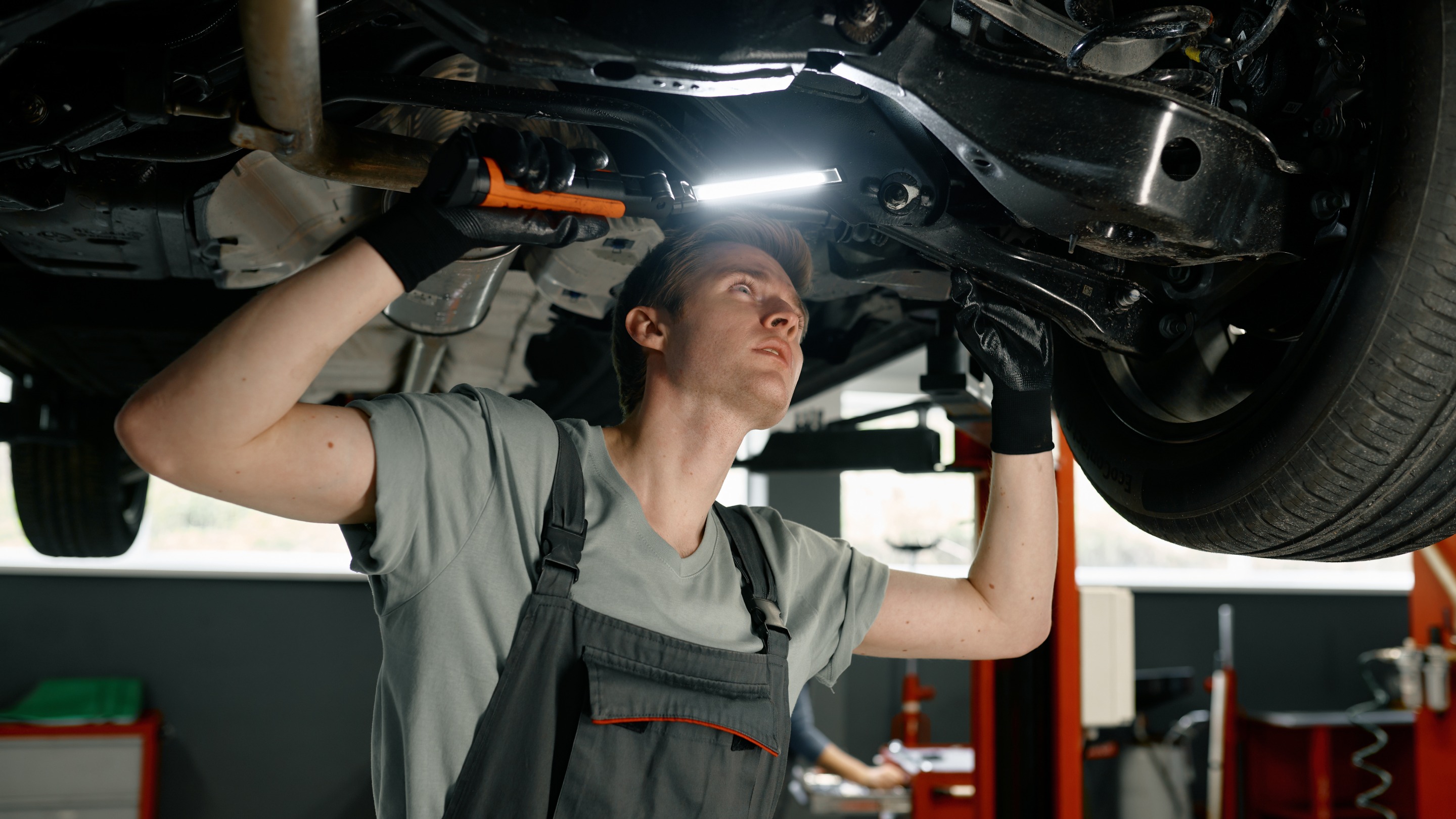 Mechanic working under car