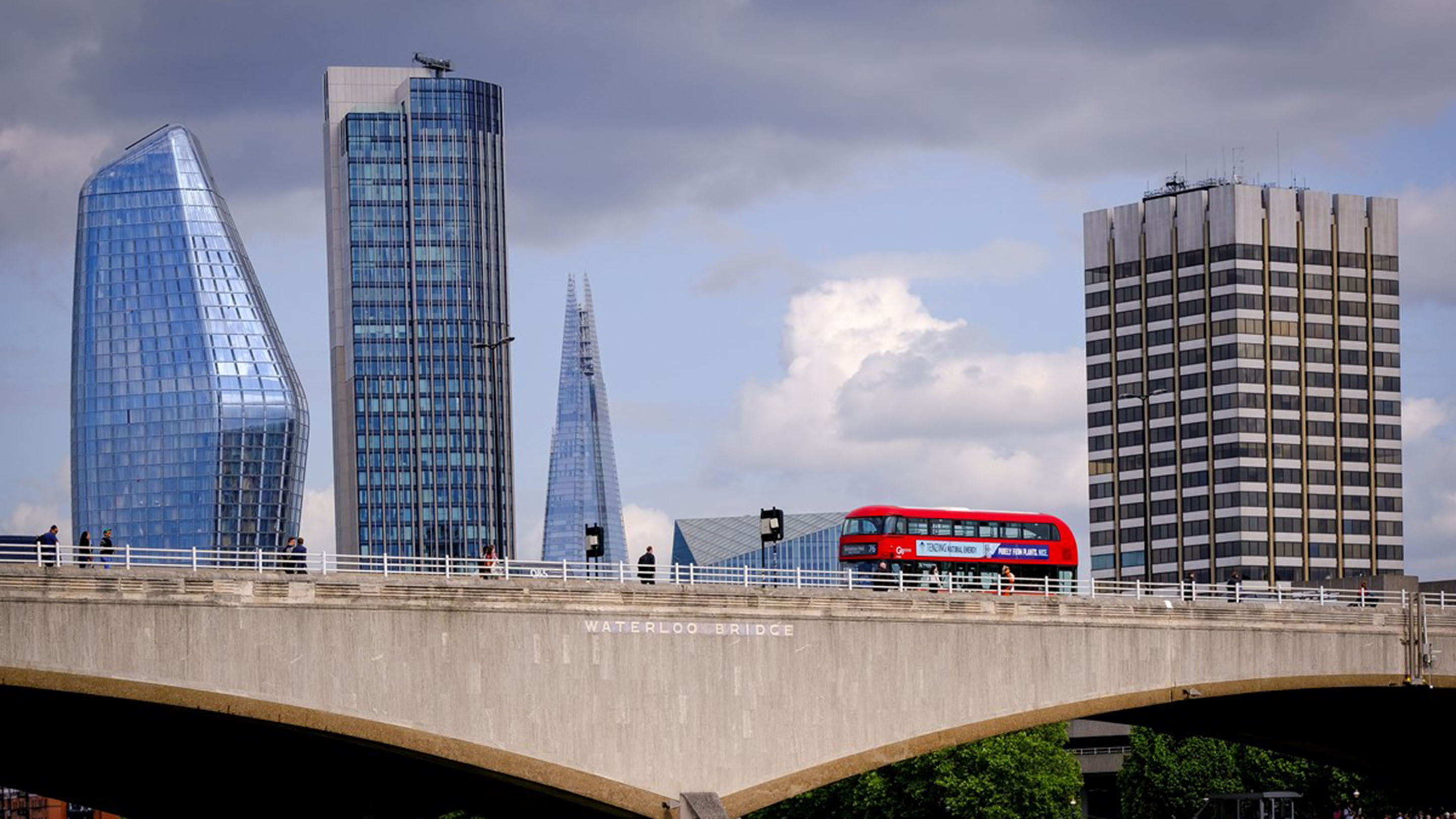 Red London bus crossing Waterloo Bridge