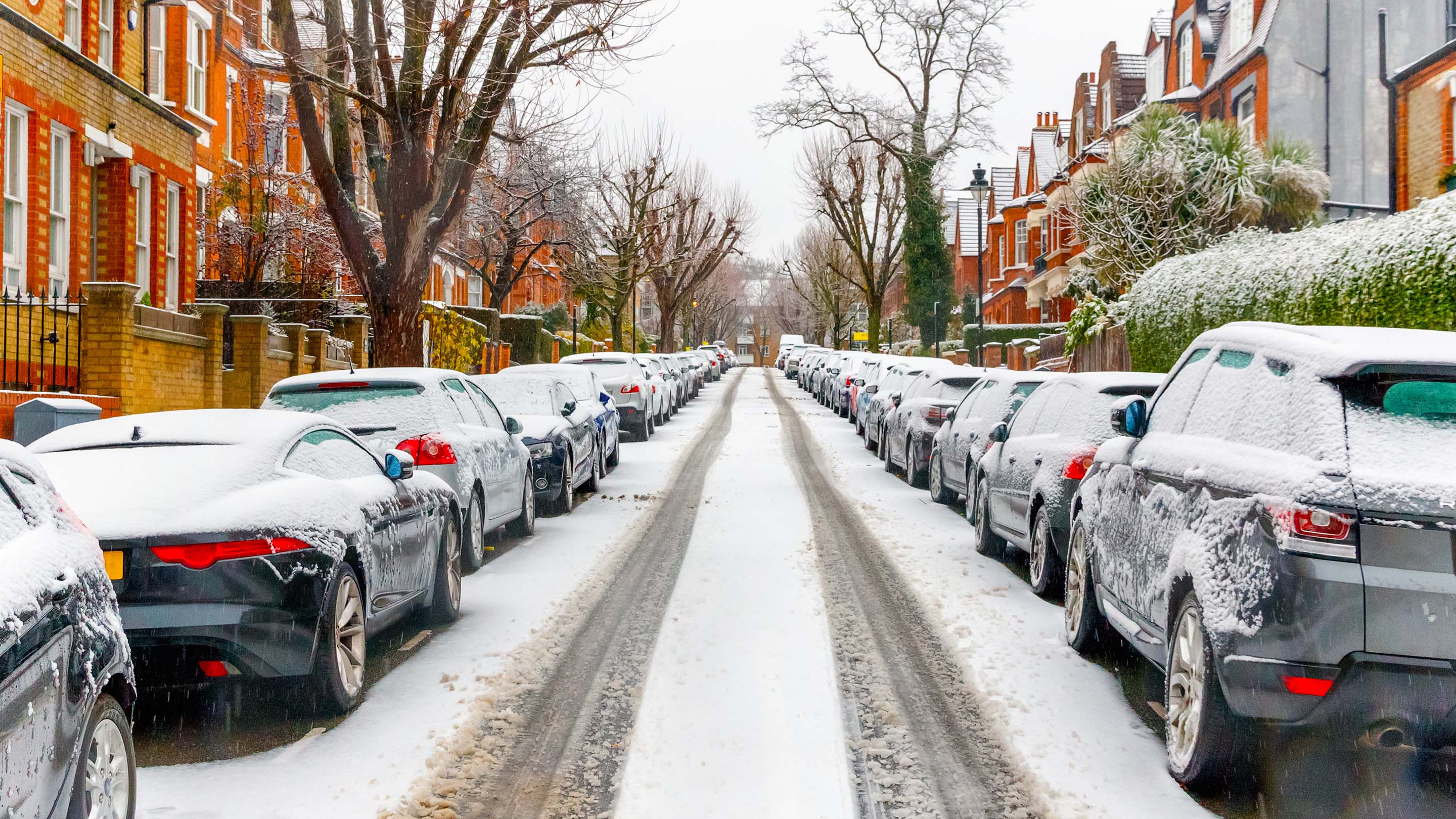 Terraced street covered with snow around West Hampstead area in London