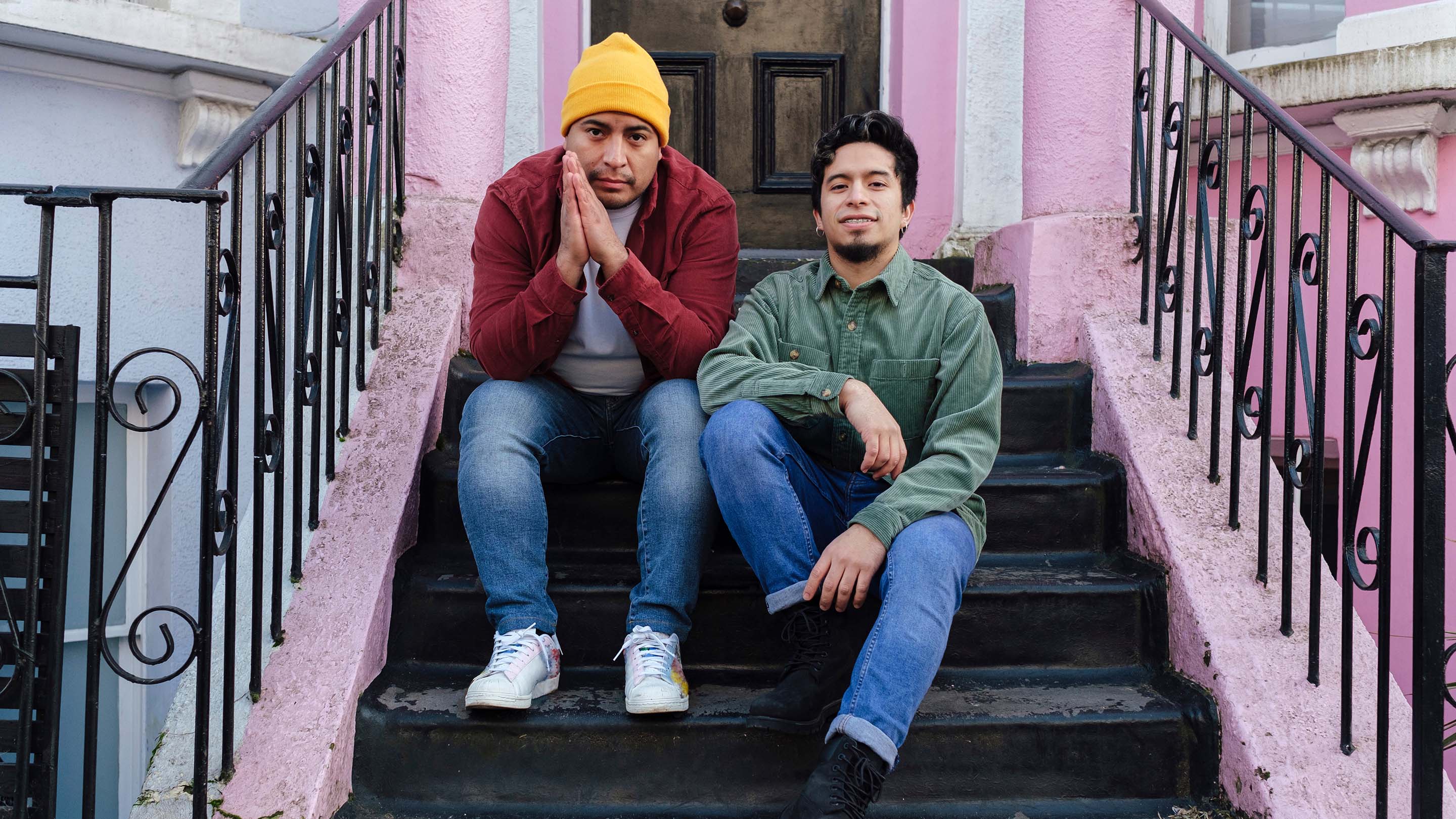 Two young men sitting on house steps