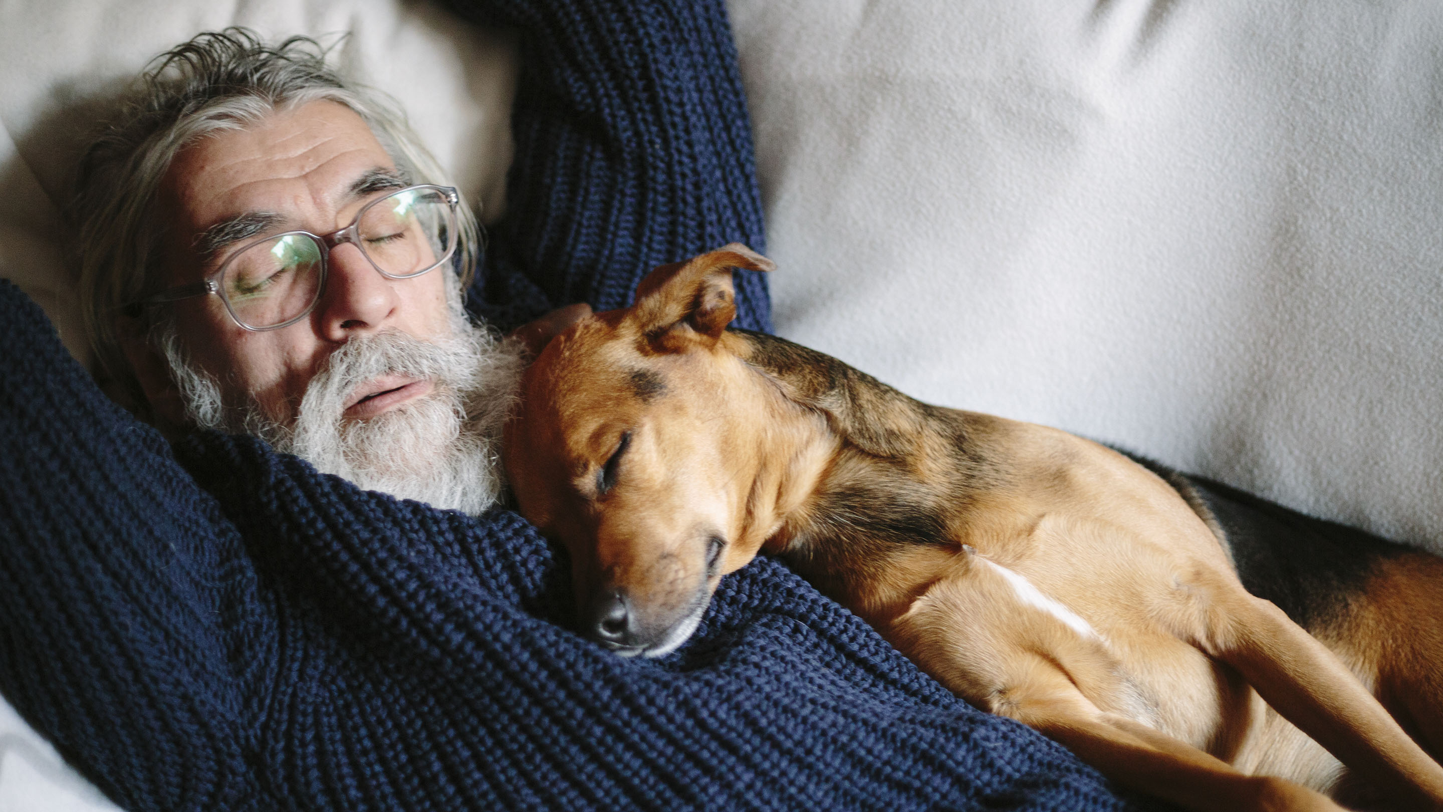 Man and dog both sleeping