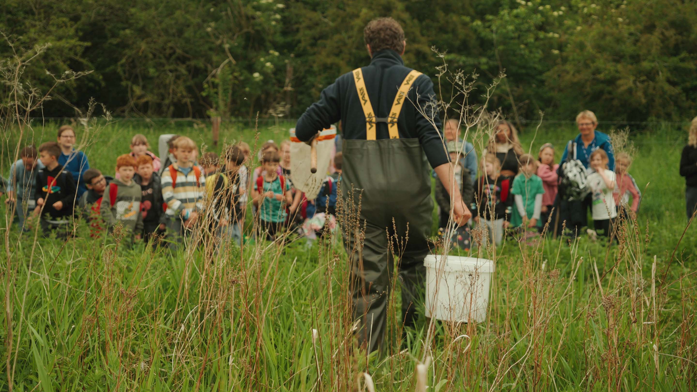 A local school group eagerly awaits the chance to learn about the creatures Tim has found in the river / Photograph © Ted Simpson / WWF-UK