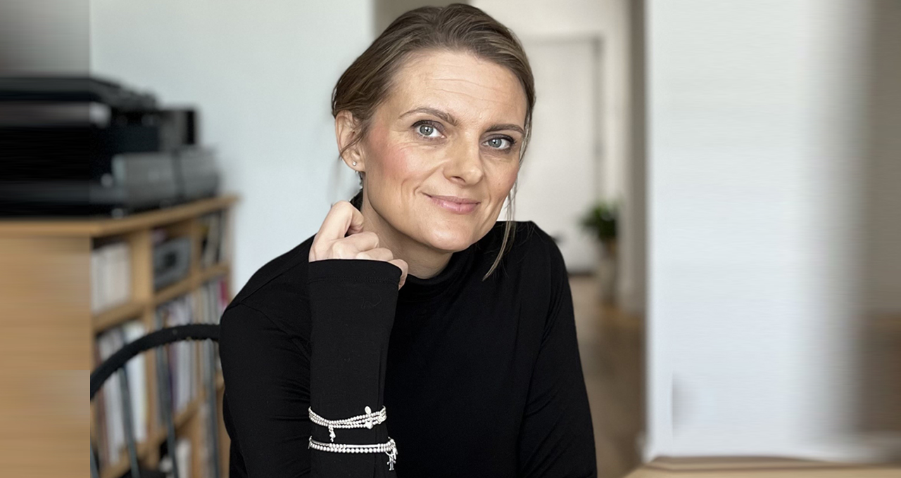 Headshot of Gemma Perry sitting at a desk