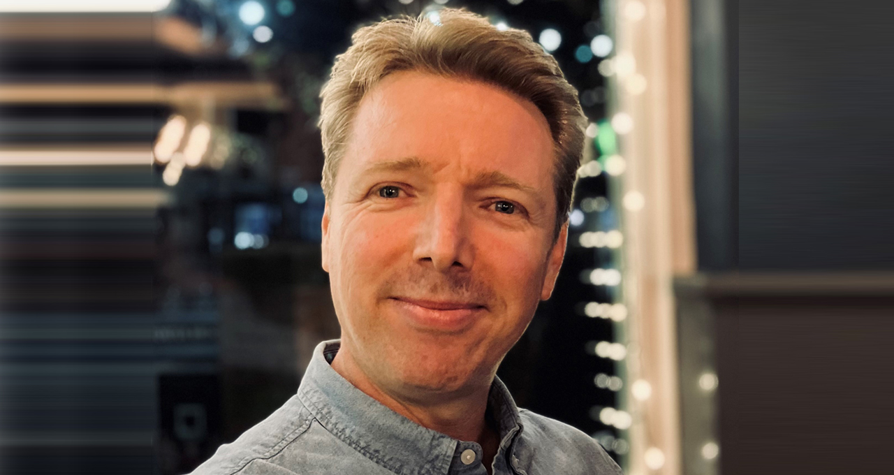 Headshot of Jim Hunter against a dark background