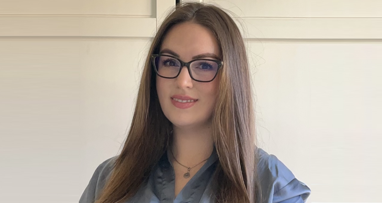 Headshot of Carolyn Bullimore, female long brown hair wearing glasses on white background
