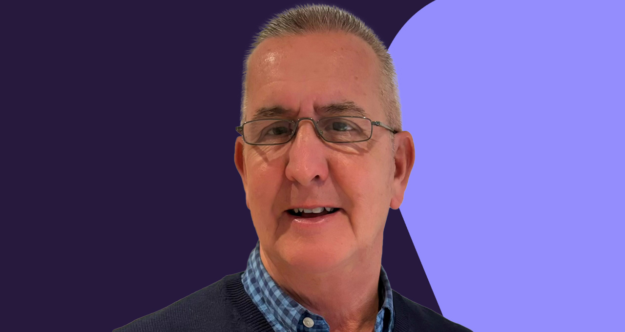 Headshot of Patrick Harvey against purple and navy backdrop