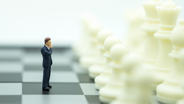 Business and work concept. Businessmen miniature mini figures standing on chessboard thinking and face to white chess pieces