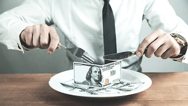 man eating money from plate