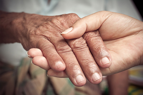 a picture of a young hand holding an older one