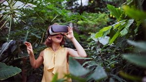 child in nature wearing a virtual reality headset