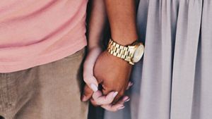 Close up of heterosexual couple holding hands