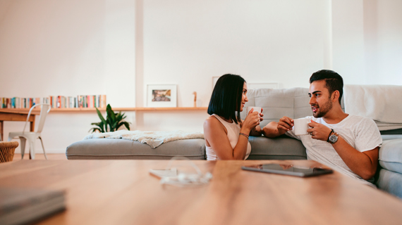 man and woman on sofa talking