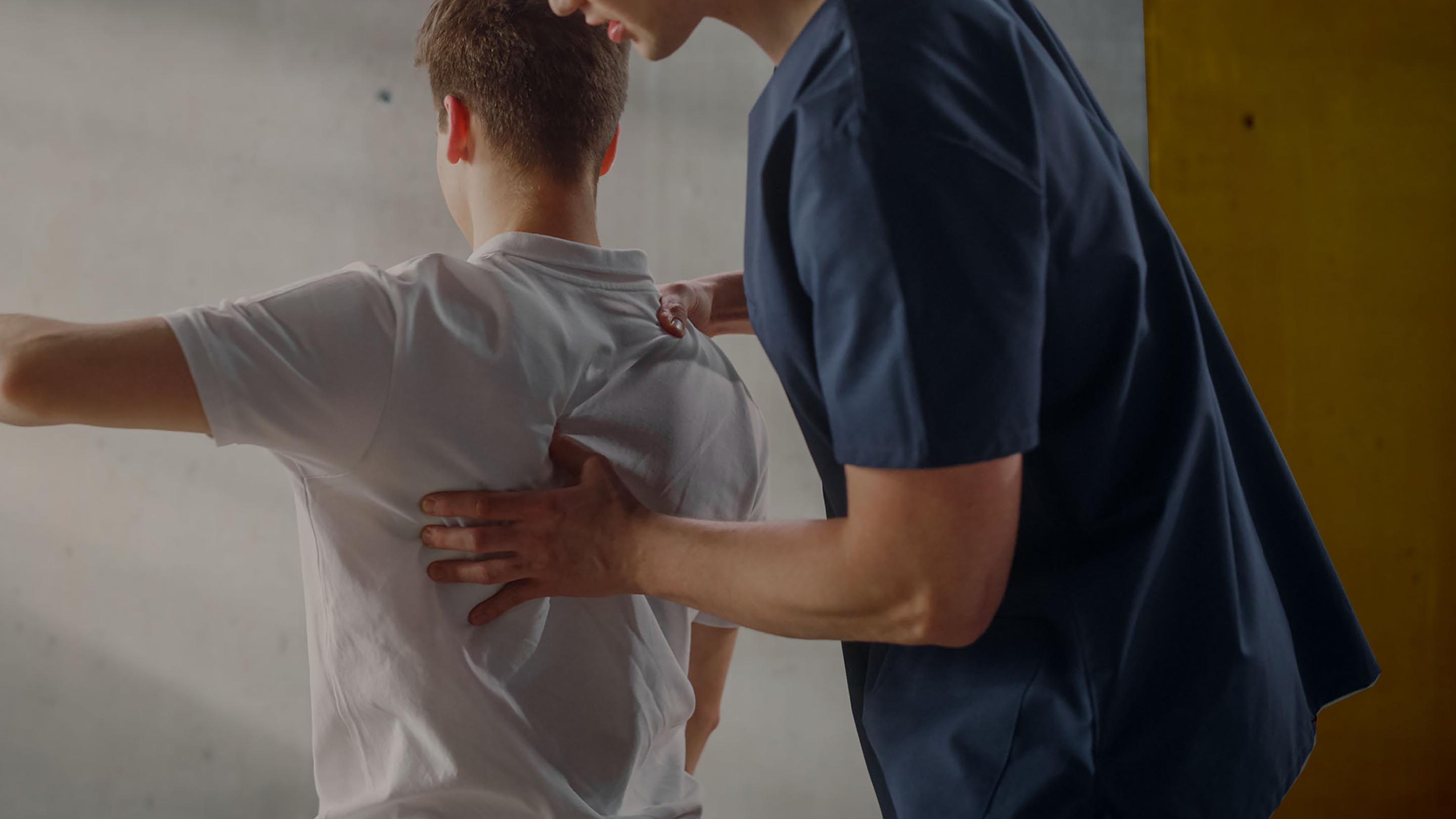 Image of a physiotherapist treating a patient with back pain