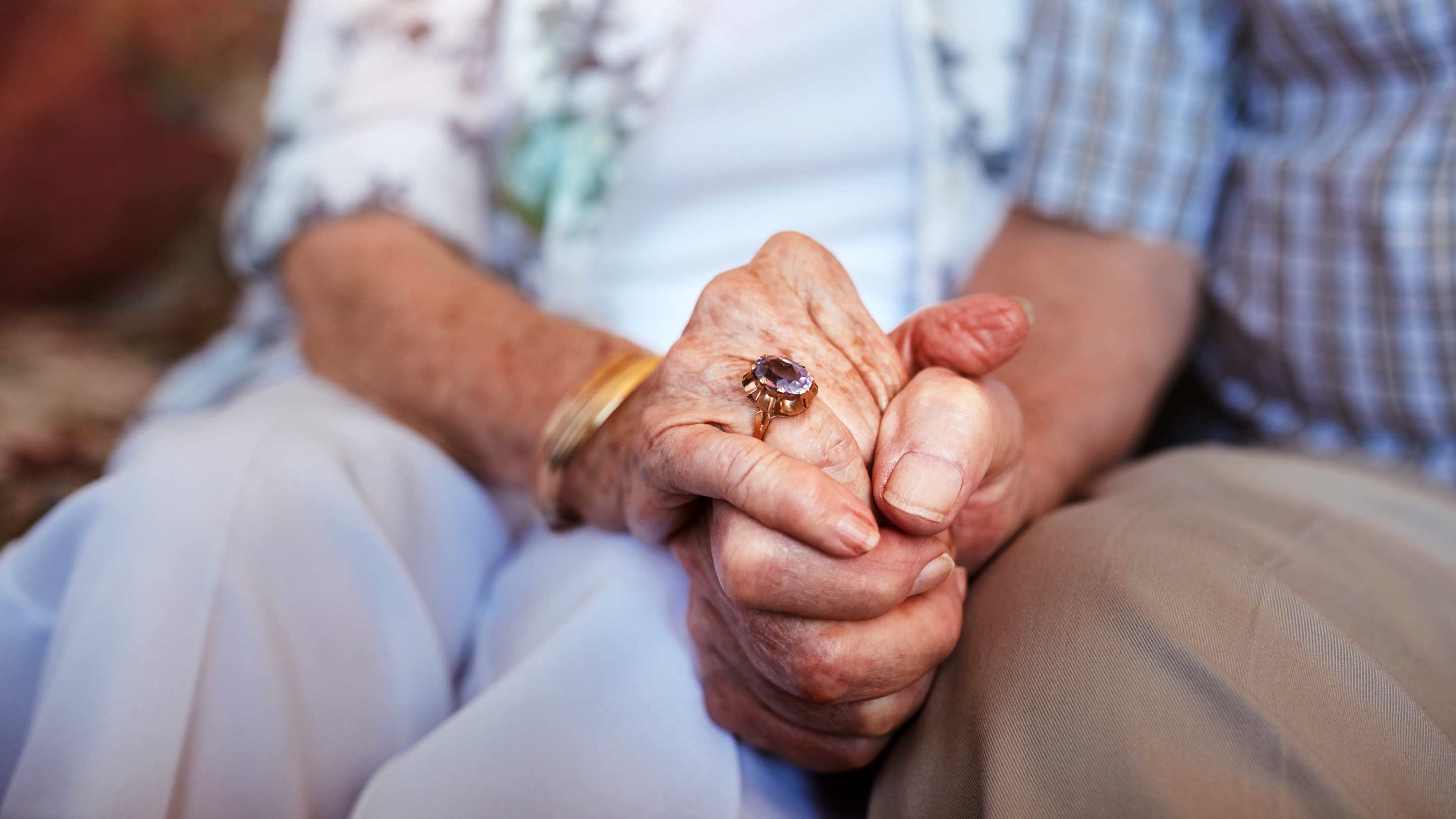 Close up of an elderly couple holding hands
