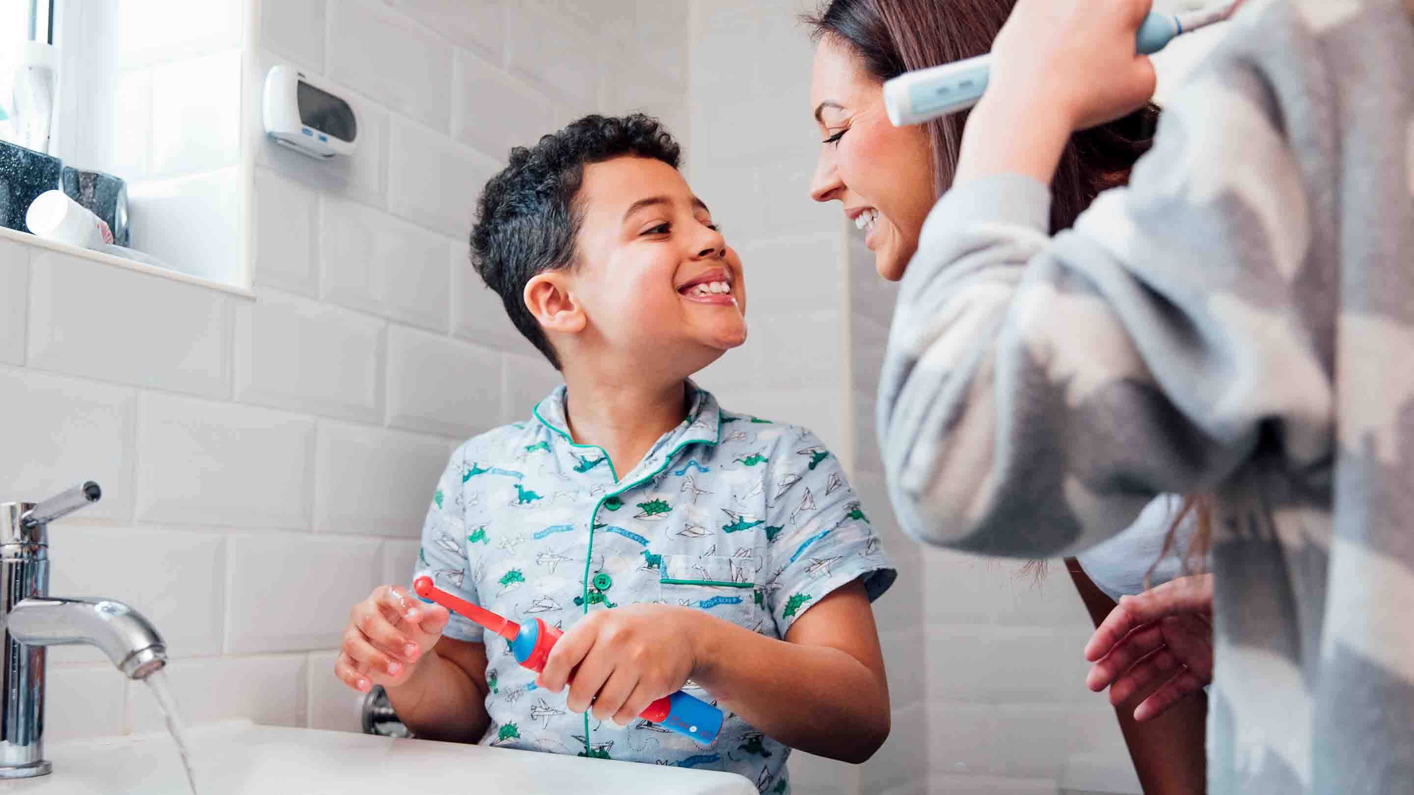 Mother checking child has brushed teeth properly