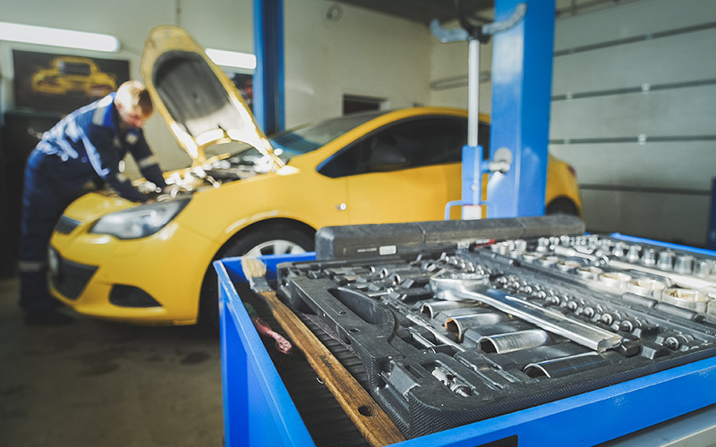 NCT mechanic testing yellow car for NCT failures from Aviva Ireland