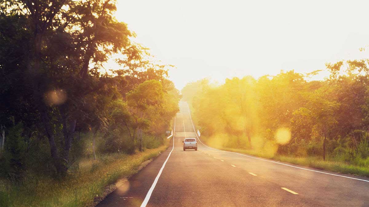 car driving on road in sunlight