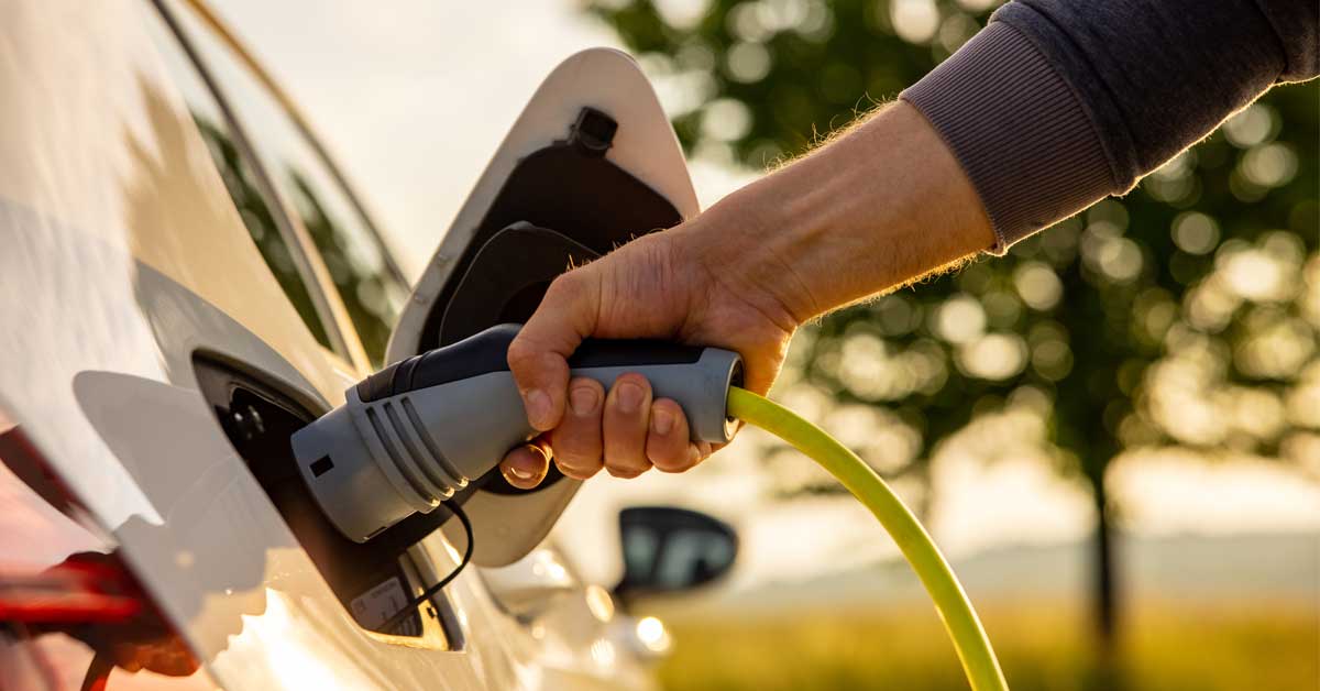 Man charging his electric car