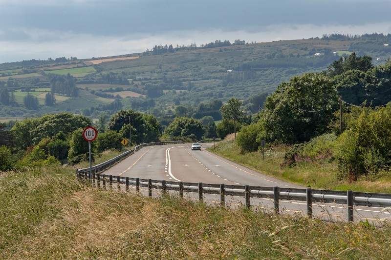 Car driving on irish road with speed limit 100km/h