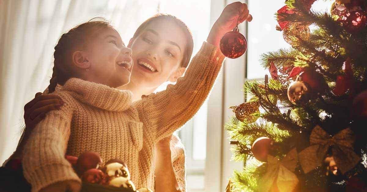 Mother and child decorating Christmas tree