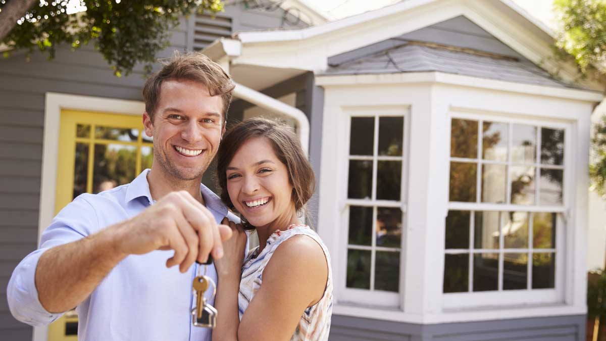 Couple happy with keys to their new home after conducting a house inspection with a checklist