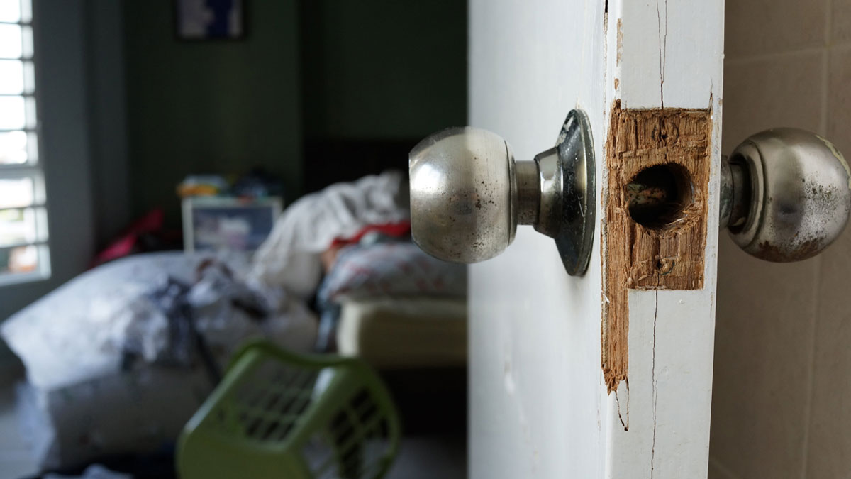 House door broken into. Learn the steps to take and who to contact if your home is burgled.