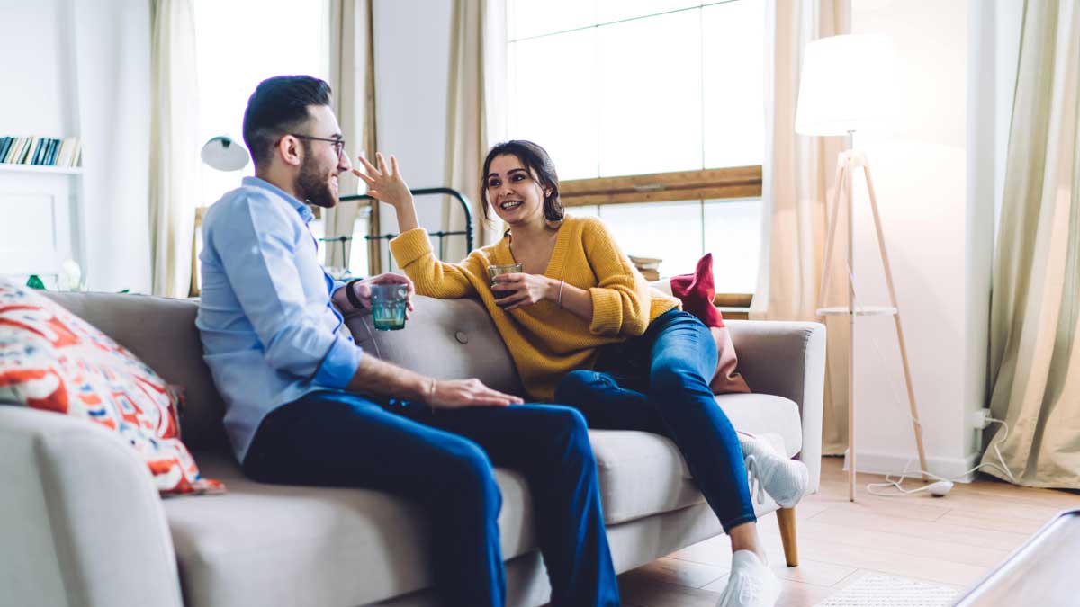 Young couple happy discussing buying life insurance in their 20s, 30s with Aviva Insurance