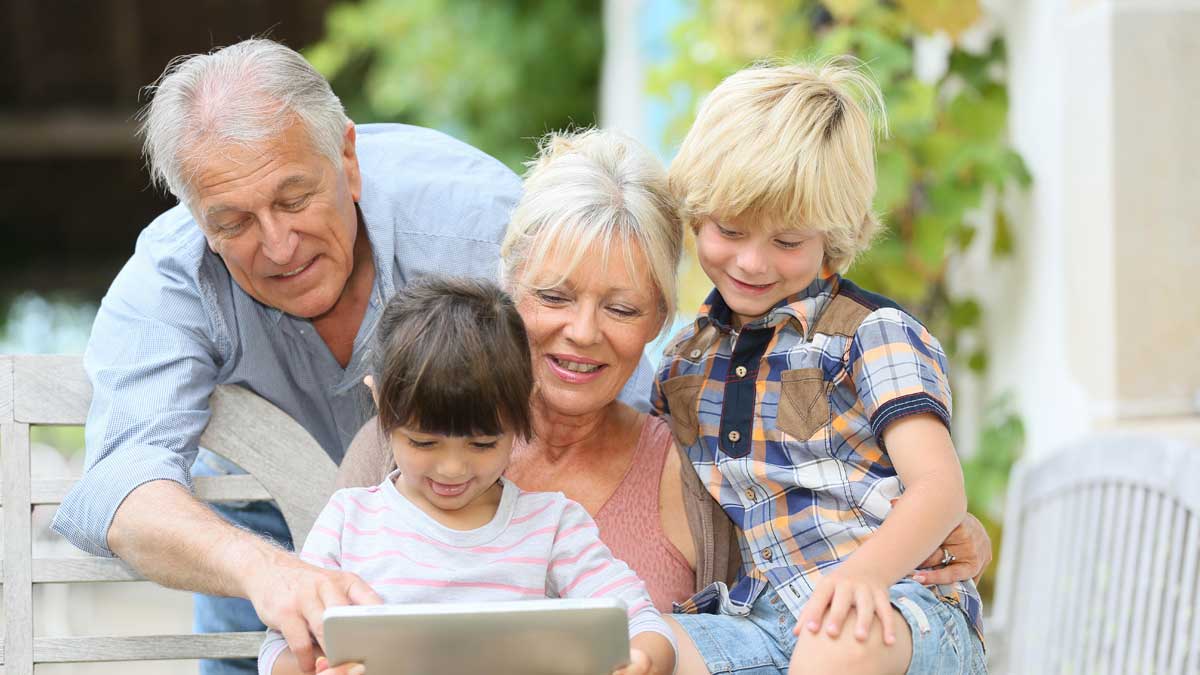 Grandparents with two grandchildren happily retired with life insurance